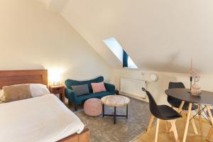 a bedroom with a bed and a table and chairs at River View Residence by Charles Bridge in Prague