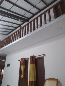 a staircase in the living room with curtains at SuPra Villa in Ginimellagaha West