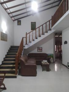 a living room with a couch and stairs at SuPra Villa in Ginimellagaha West