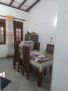 a dining room with a table and chairs at SuPra Villa in Ginimellagaha West