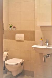 a bathroom with a toilet and a sink at Apartament Garbary22 in Bydgoszcz +23 photos