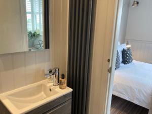 a bathroom with a sink and a bed at The Old Bell B&B in Grimston +50 photos
