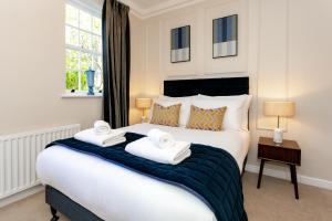 a bedroom with a large white bed with towels on it at New Holgate in York
