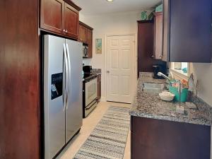a kitchen with a stainless steel refrigerator at Dawn 315-saltwater Escape in Galveston