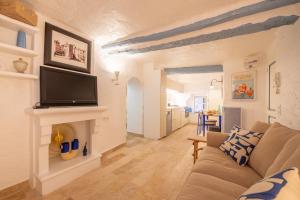 a living room with a couch and a fireplace at Appartement vieux village - La Ponche in Saint-Tropez +2 photos
