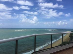 a view of the ocean from a balcony at Ocean Flat 1006 in Vila Velha