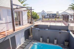 a balcony with a swimming pool on a house at Waterfront- C25 Knysna Quays with pool in Knysna