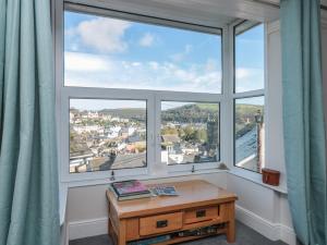 a room with a large window with a wooden table at 8 Above Town in Dartmouth
