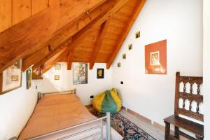a bedroom with a bed and a wooden ceiling at Titti in Anzino