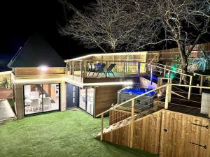 a large house with a large deck at night at Chalet et Jaccuzy sur la plage in Biscarrosse