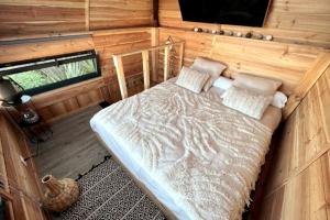 une chambre avec un lit dans une pièce en bois dans l'établissement Chalet et Jaccuzy sur la plage, à Biscarrosse 17 autres photos