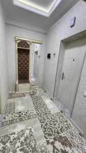 um quarto vazio com uma porta e um piso de azulejo em APARTMENT «СЕМЬЯ» em Tashkent