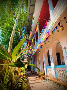 a building with colorful flags hanging from the ceilings at Paradise Inn Beach Resort in Varkala