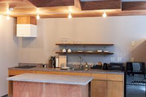 a kitchen with wooden cabinets and a counter top at Stay UWU 001 ステイ ウー 001 in Kochi