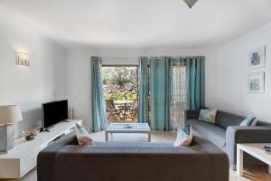 a living room with a couch and a tv at Blue Dream Pebble Beach in San Miguel de Abona