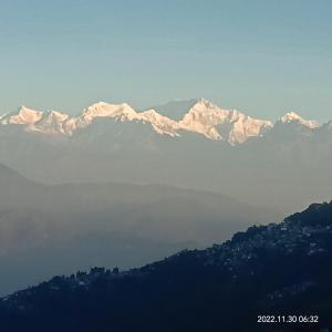 a group of snow capped mountains in the distance at Wonder Hill Parivaar homestay in Darjeeling