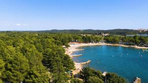 an aerial view of a beach with people in the water at Easyatent Camping Valkanela in Vrsar