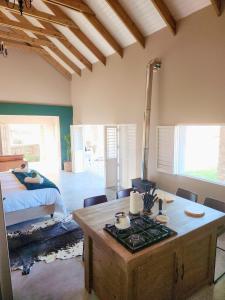 a bedroom with a bed and a table in a room at Bella Casetta at Village-Living in Koringberg