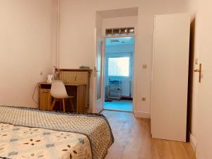 a bedroom with a bed and a desk and a table at Nice private room in Luxembourg City in Luxembourg +6 photos
