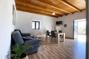a living room with a couch and a table at Tindaya Sol Smartworking by Babiniliving in Tindaya
