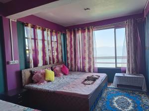 a bedroom with a bed with purple walls and windows at Wonder Hill Parivaar homestay in Darjeeling