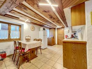 a kitchen and dining room with a table and chairs at Les Antilles l Bucolique l 6pers in Vercorin