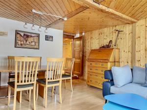 a dining room with a table and chairs and a couch at Les Antilles l Bucolique l 6pers in Vercorin