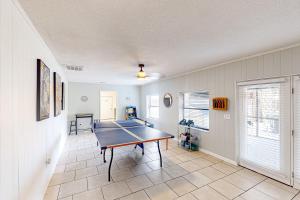 a living room with a ping pong table in it at Beach Life in Panama City Beach