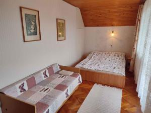 a small room with two beds and a couch at Holiday home in Revfülöp - Balaton 36498 in Révfülöp