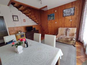 a dining room with a table and a chair at Holiday home in Revfülöp - Balaton 36498 in Révfülöp