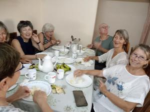 a group of people sitting at a table eating food at Sheeba's Homestay in Cochin