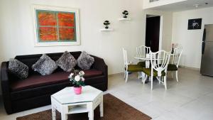 a living room with a couch and a table at Lakeshore Towers, Cluster Y , JLT, 1BHK in Dubai