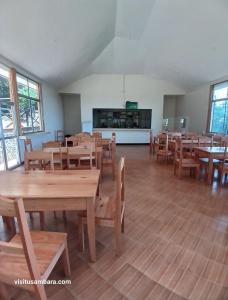 an empty classroom with wooden tables and chairs at Camping Magamba Forest in Lushoto