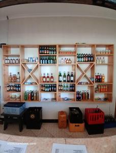 a shelf in a room filled with lots of bottles at Camping Magamba Forest in Lushoto