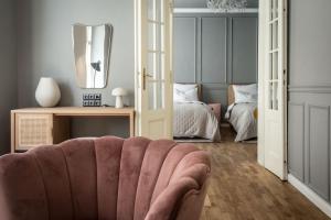 a living room with a couch and a bedroom at Domus Balthasar Boutique Hotel in Prague