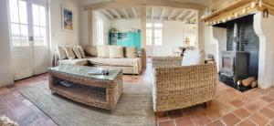 a living room with a couch and a table and a fireplace at Charmante Maison dans Les Landes x 10 avec piscine et salle d escalade in Lue