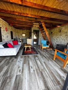 a living room with a couch and a table at Panpubungalov in Pazar