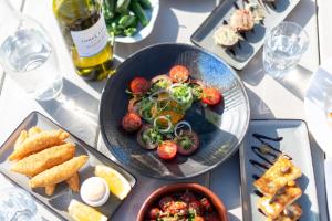 a table with a plate of food on a table at Three Choirs Vineyards in Newent