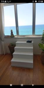 a set of stairs in a room with a window at שרון על המים in Herzliyya B
