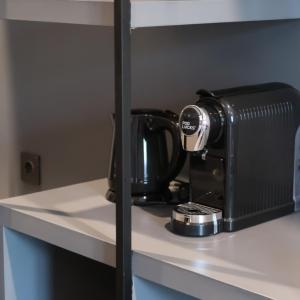a coffee maker on a shelf in a room at Fhandika Boutique Inc. in Geutieue
