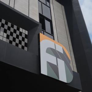 a sign on the side of a building at Fhandika Boutique Inc. in Geutieue