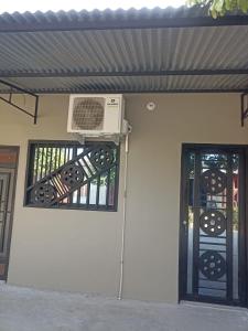 a house with a air conditioner on the wall and a door at Alojamiento la esmeralda in Puerto Triunfo