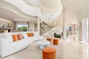 a living room with a white couch and a table at All About La Redonda Villa in Estepona