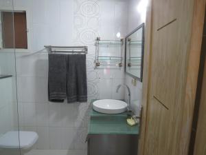 a small bathroom with a sink and a toilet at Beautiful appartment with a glorious sea view in Monastir +29 photos