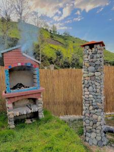 a stone oven with smoke coming out of it at Panpubungalov in Pazar