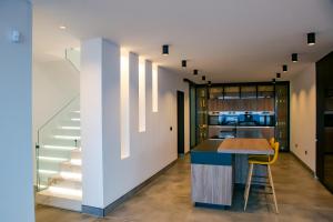 a kitchen and dining area with a counter and stairs at Villa Infinity in Playa Blanca