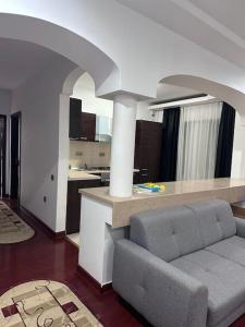 a living room with a couch and a kitchen at Apartament Complex in Bucharest