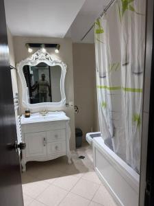 a bathroom with a sink and a mirror and a tub at Apartament Complex in Bucharest