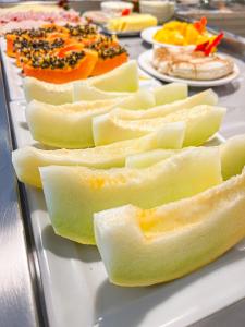 a plate of food with fruit on a table at Pousada Cabanas Rota do Sol in Gramado