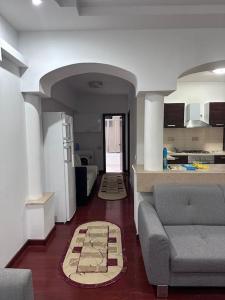 a living room with a couch and a kitchen at Apartament Complex in Bucharest